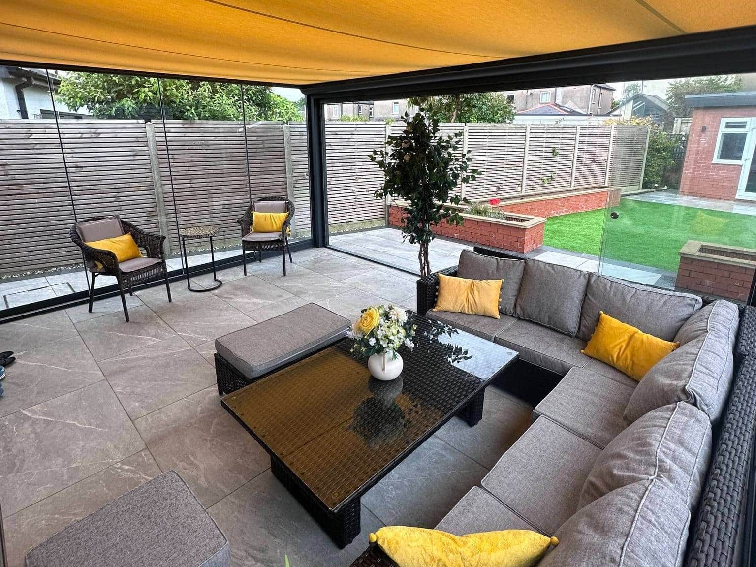 Interior of anthracite grey glass veranda with sliding doors and awning