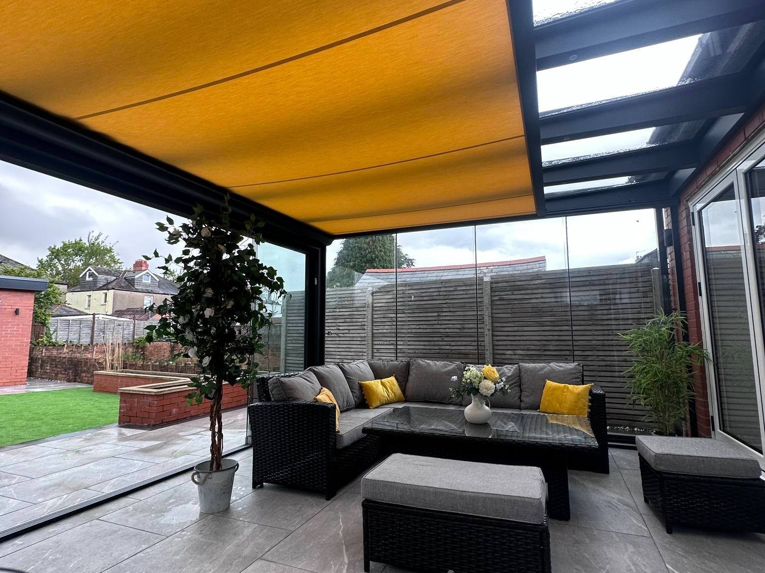 Anthracite grey glass veranda with sliding doors and awning