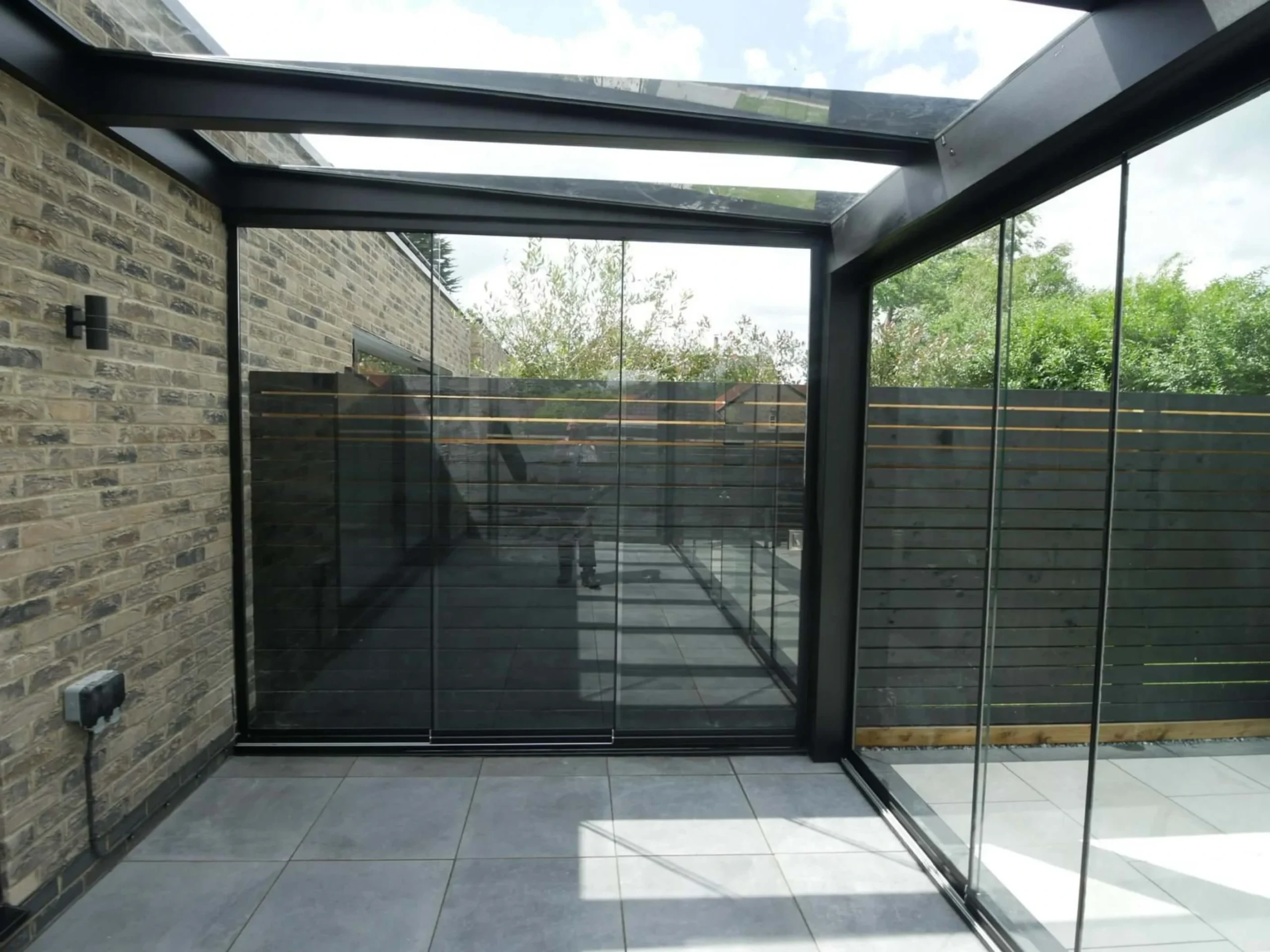 Jet black aluminium frame glass room veranda with lockable glass sliding doors